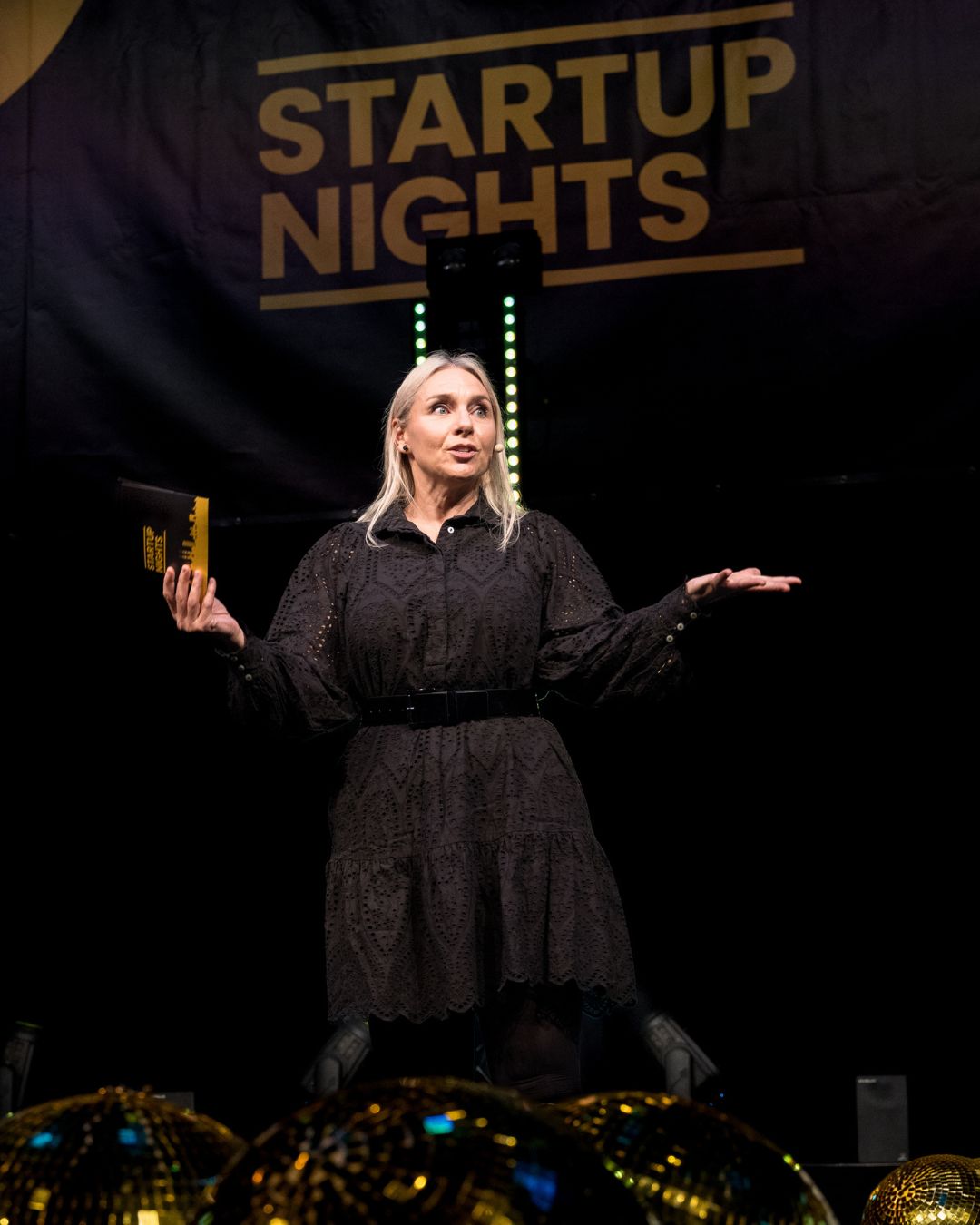 Blazy Flash on stage beneath the Startup Nights logo in Winterthur
